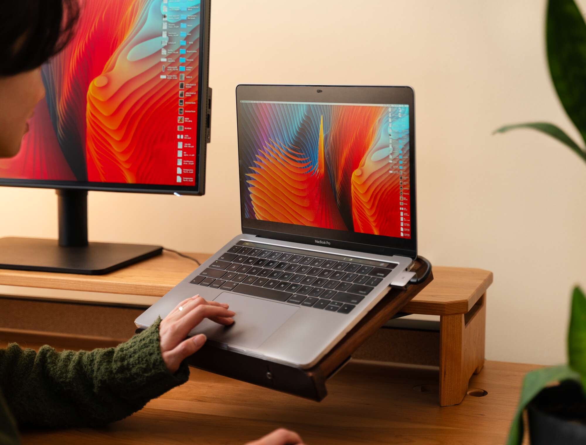 Laptop Holder - person using laptop on holder at desk