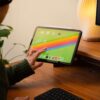 Tablet Holder - person touching tablet on holder at desk